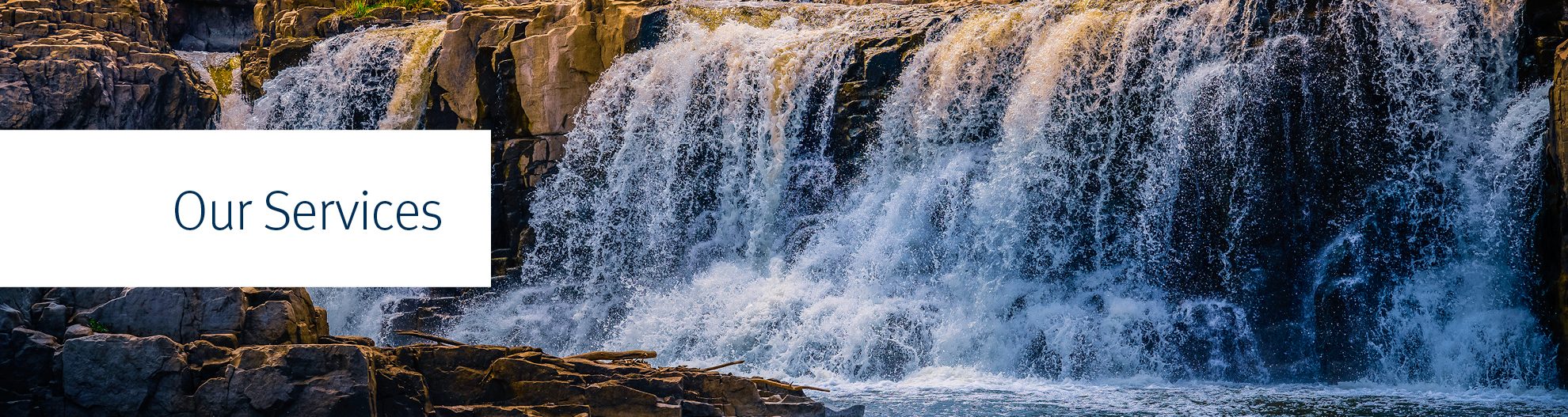 Dramatic sunset at Falls Park in Sioux Falls, South Dakota, USA, Big Sioux River water falling over quartzite and pipestone rock formations